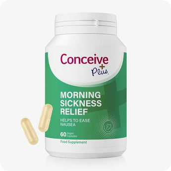 Conceive Plus Morning Sickness Relief bottle featuring 60 vegan capsules, shown front-facing with green and white label design that highlights nausea support and natural ginger content, accompanied by two beige capsules floating beside container.