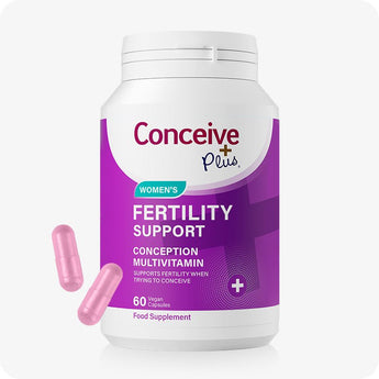 For Conceive Plus Women's Fertility Support and Ovulation Support Bundle, Women's Fertility Support bottle in rich purple with white cap, labeled as a conception multivitamin with 60 vegan capsules; two pink capsules are positioned near bottle on white background.